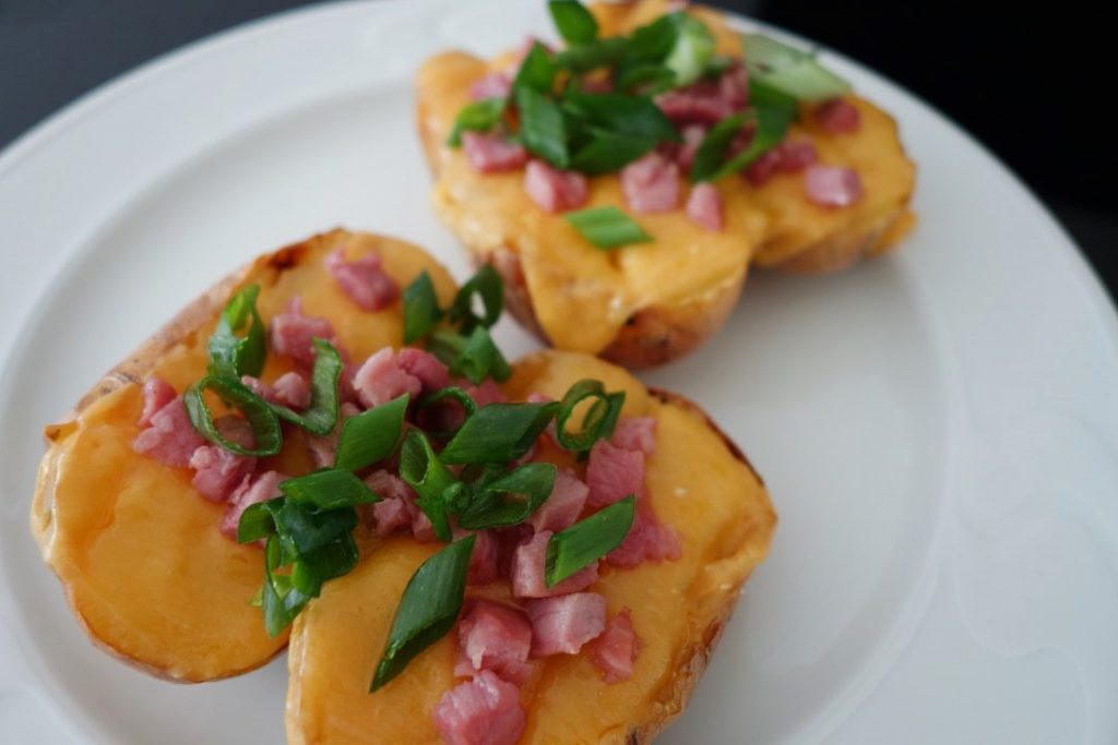 Baked potatoes with cheese, bacon and spring onions