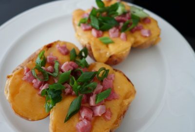 Baked potatoes with cheese, bacon and spring onions